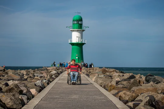 Rollstuhlfahrer an der Westmole in Warnemünde Rollstuhlfahrer an der Westmole in Warnemünde